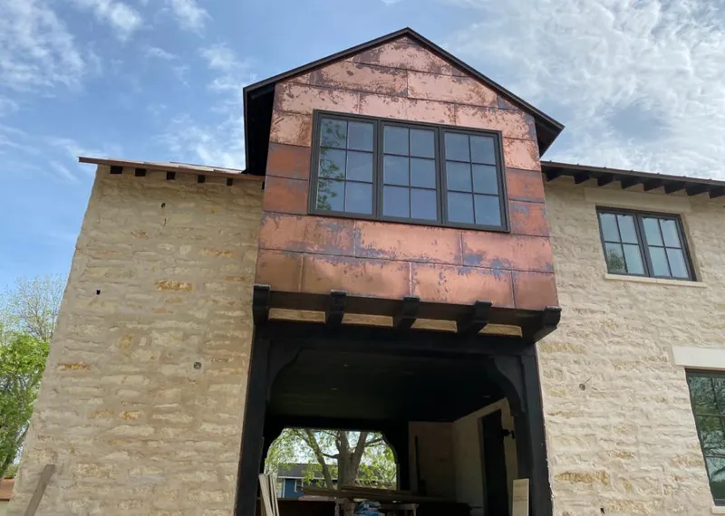 Copper metal panel facade on a stone building for Metal Roof Coating in Mountlake Terrace