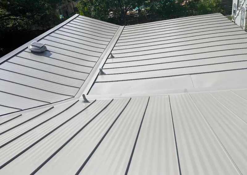 Solar attic fan installed on a metal roof for Roof Ventilation in Mountlake Terrace